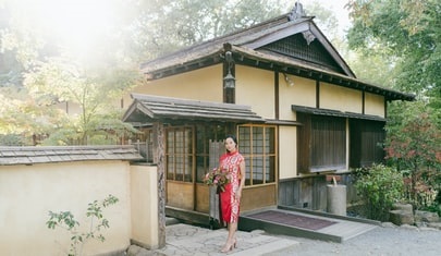 Lady standing in front of her house